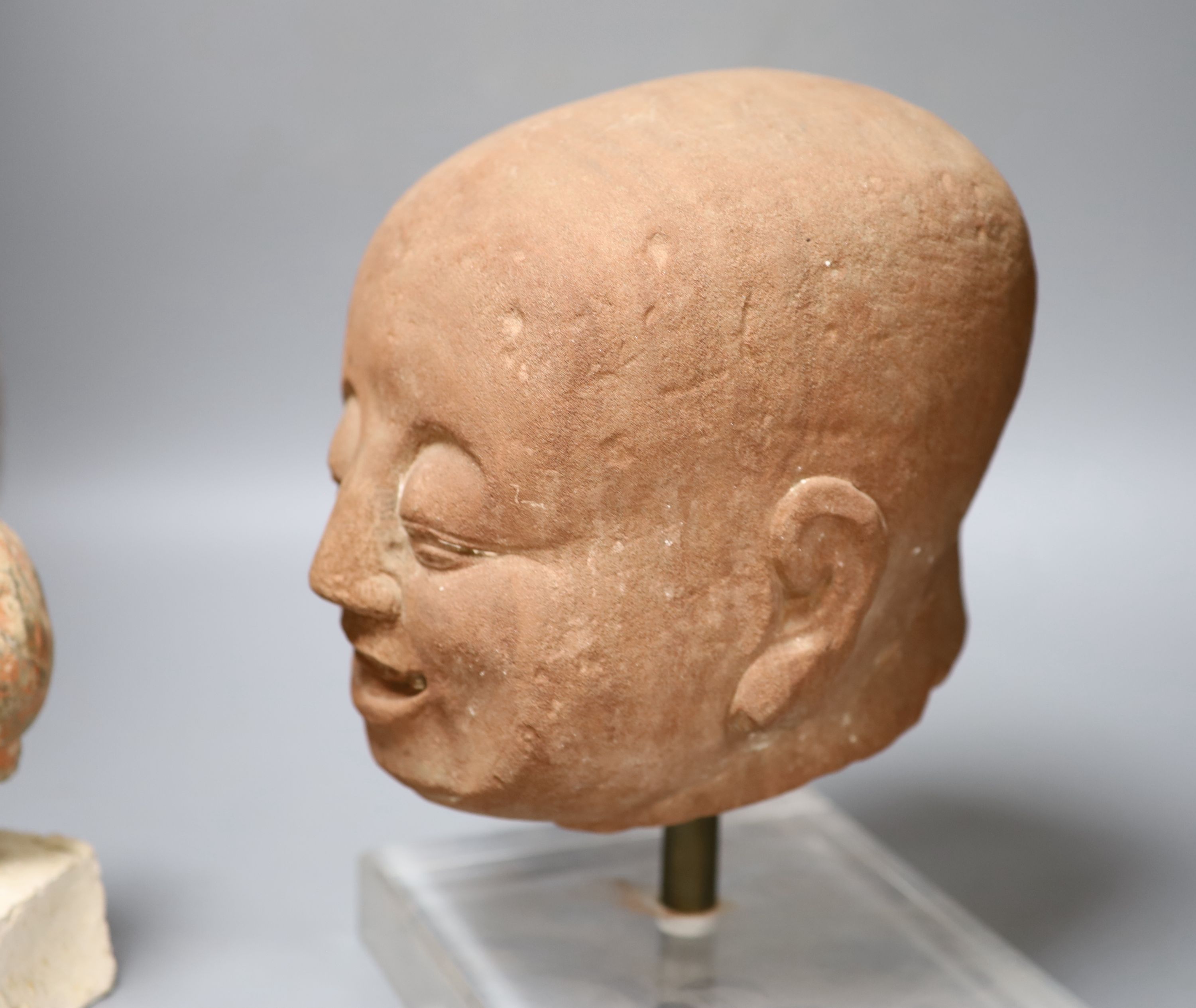 Two Chinese terracotta heads, tallest overall 30cm